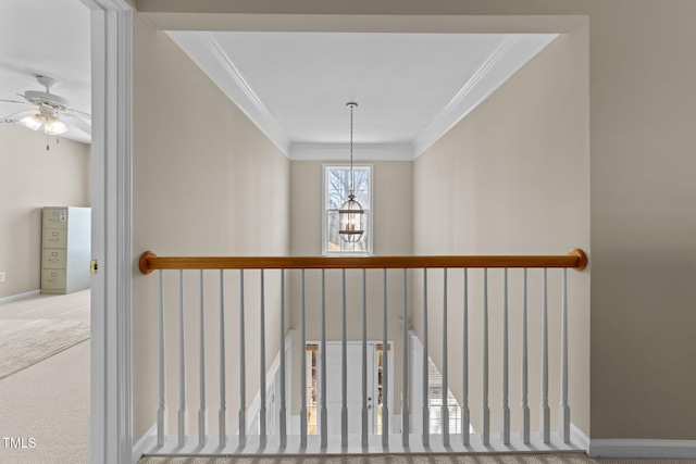 hall featuring crown molding and a chandelier