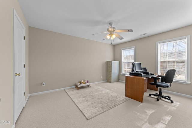 office space with light colored carpet and ceiling fan