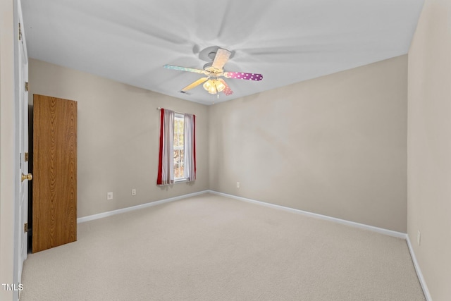 unfurnished room with ceiling fan and light colored carpet