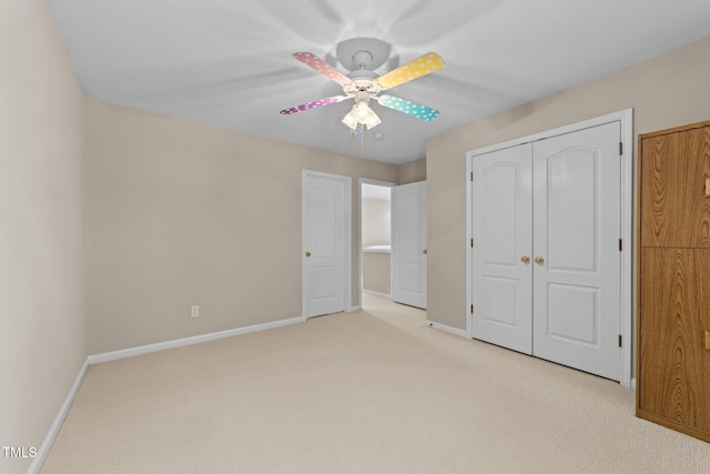 unfurnished bedroom featuring light carpet, a closet, and ceiling fan