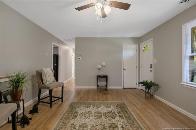 foyer with ceiling fan and light wood-type flooring