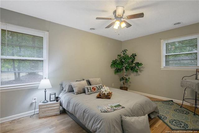 bedroom with ceiling fan and light wood-type flooring