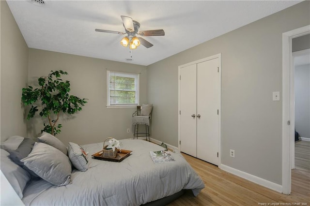 bedroom featuring a closet, ceiling fan, and light hardwood / wood-style flooring