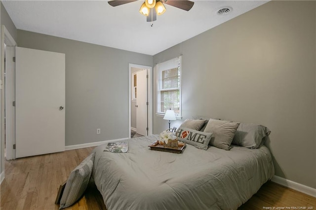 bedroom with light hardwood / wood-style floors and ceiling fan