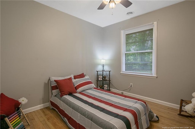 bedroom with ceiling fan and light wood-type flooring