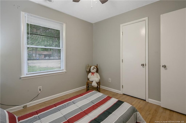 bedroom with ceiling fan and light hardwood / wood-style floors