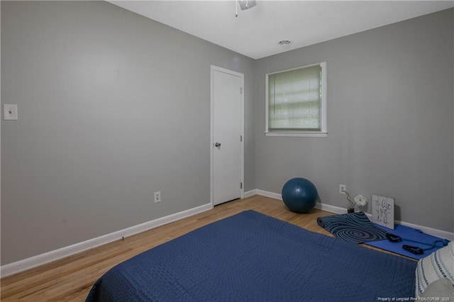 exercise room with hardwood / wood-style flooring and ceiling fan