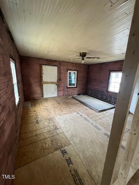 interior space featuring wooden ceiling and ceiling fan