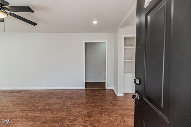 empty room featuring dark hardwood / wood-style floors and ceiling fan