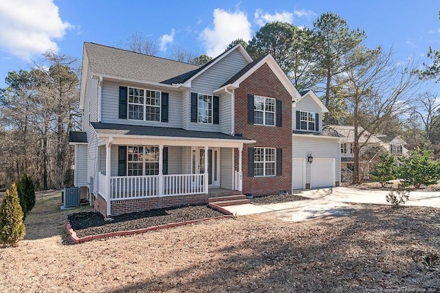 front facade with central AC unit, a garage, and a porch