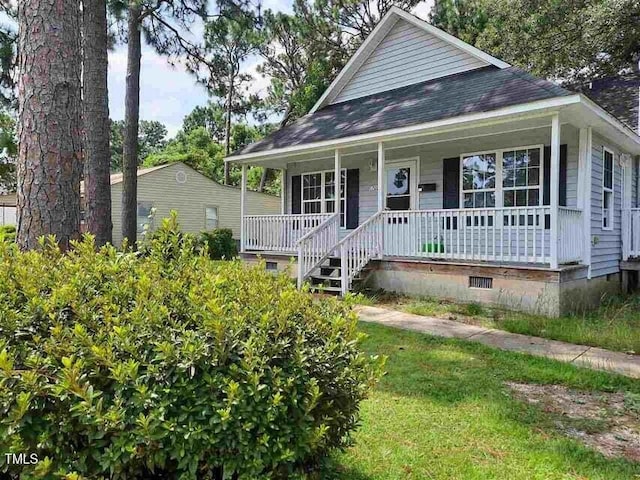 view of front of property with crawl space, covered porch, and a front yard