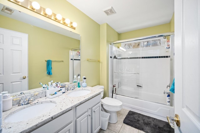 full bathroom featuring bath / shower combo with glass door, vanity, tile patterned floors, and toilet