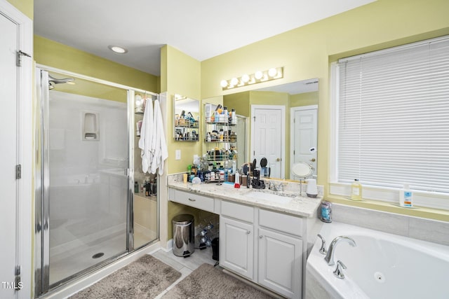 bathroom featuring vanity, tile patterned flooring, and separate shower and tub