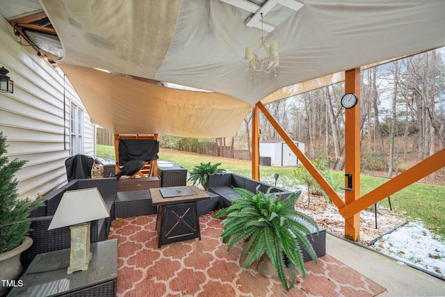 view of patio featuring an outdoor living space with a fire pit and a storage unit