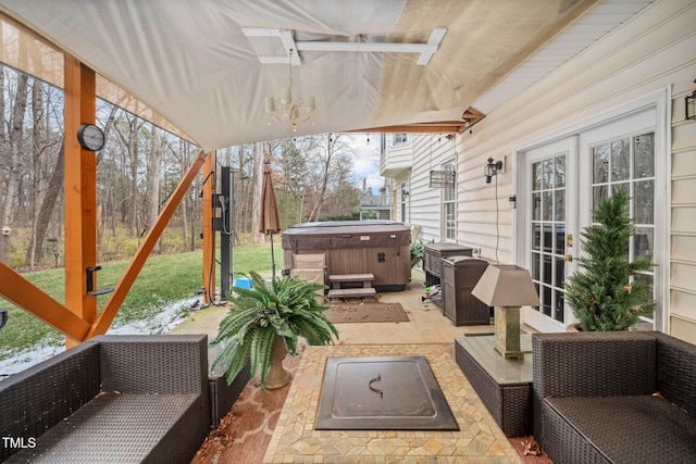 view of patio / terrace featuring an outdoor hangout area, a hot tub, and french doors