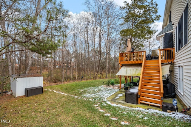 view of yard featuring a deck and a storage unit