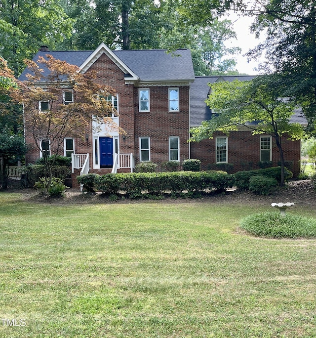 colonial-style house with a front lawn