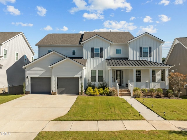 modern inspired farmhouse featuring a garage, covered porch, and a front lawn