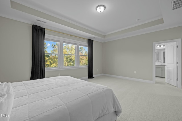 bedroom with crown molding, light colored carpet, and a raised ceiling