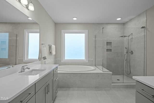 bathroom with vanity, plus walk in shower, and tile patterned flooring