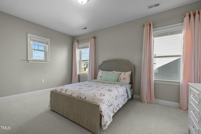 bedroom featuring light carpet