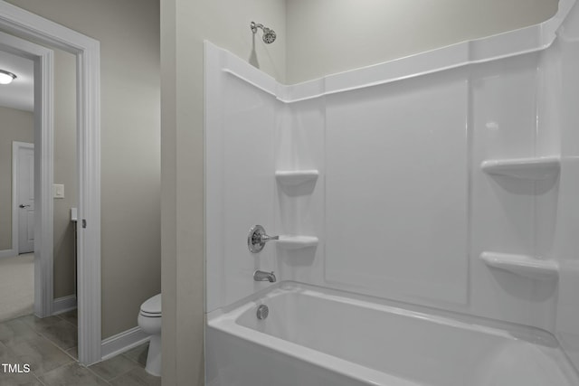 bathroom featuring toilet and washtub / shower combination