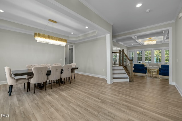 dining area featuring crown molding, light hardwood / wood-style floors, and a chandelier