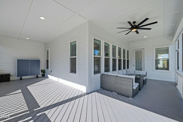 wooden terrace featuring an outdoor living space and ceiling fan