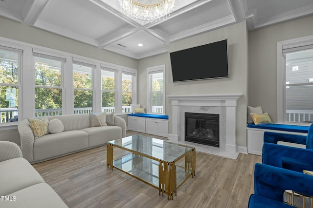 living room with coffered ceiling, a notable chandelier, a fireplace, light hardwood / wood-style floors, and beamed ceiling