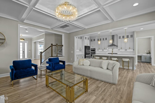 living room featuring coffered ceiling, a notable chandelier, light hardwood / wood-style floors, and beamed ceiling