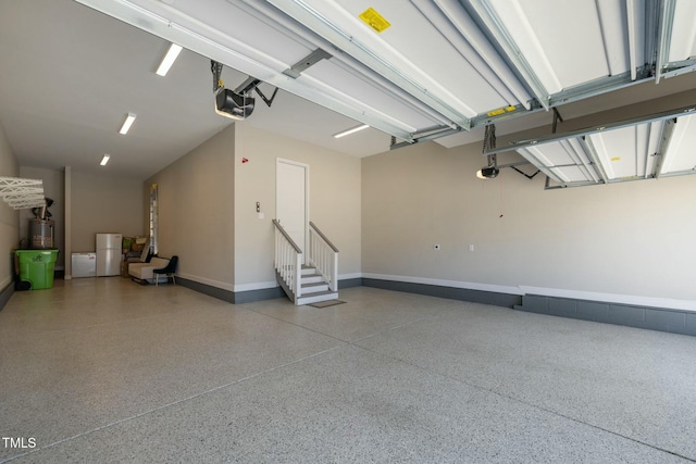 garage with a garage door opener and gas water heater