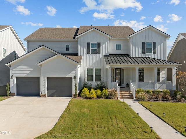 modern inspired farmhouse featuring a porch, a garage, and a front yard