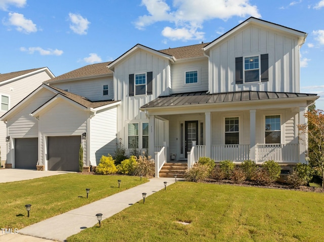 view of front facade featuring a porch, a garage, and a front yard