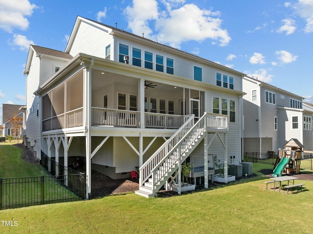 back of property featuring a playground, a lawn, cooling unit, ceiling fan, and a sunroom