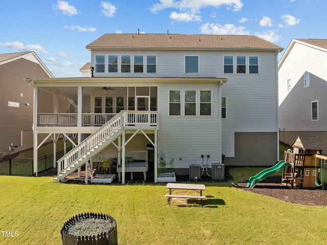 back of house with cooling unit, a lawn, a sunroom, and ceiling fan