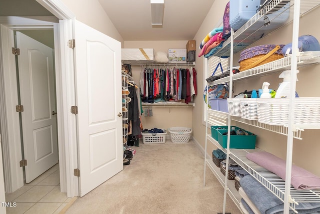 walk in closet with light tile patterned flooring