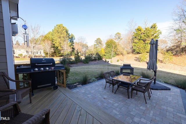 deck with a patio area, grilling area, and a lawn