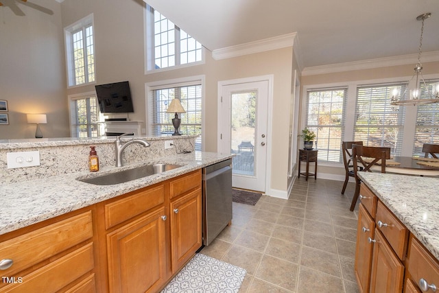 kitchen with sink, crown molding, dishwasher, light stone counters, and decorative light fixtures