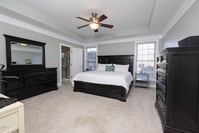 carpeted bedroom with crown molding, ceiling fan, connected bathroom, and a raised ceiling