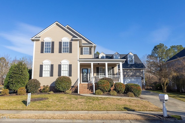 front of property featuring a garage, a front lawn, and a porch