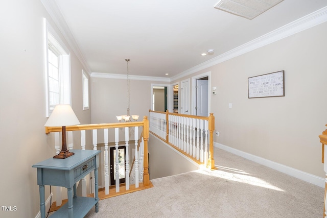 corridor featuring ornamental molding, carpet flooring, and a chandelier