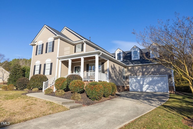 view of front of home with a garage, a front lawn, and covered porch