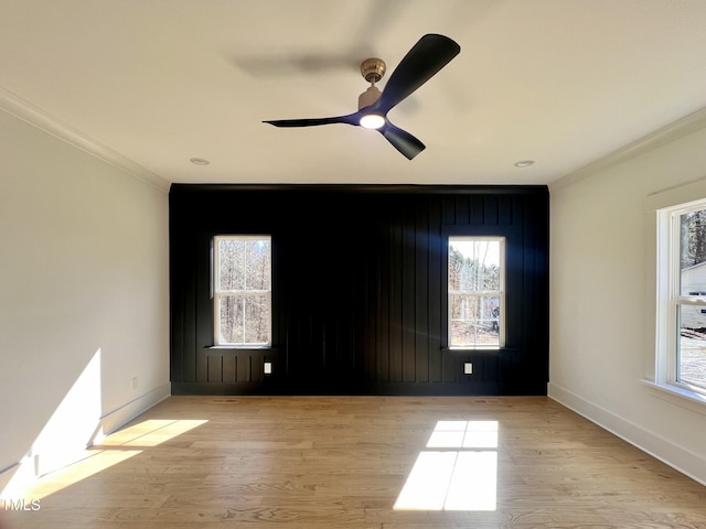 unfurnished room with a healthy amount of sunlight, ceiling fan, light hardwood / wood-style floors, and ornamental molding