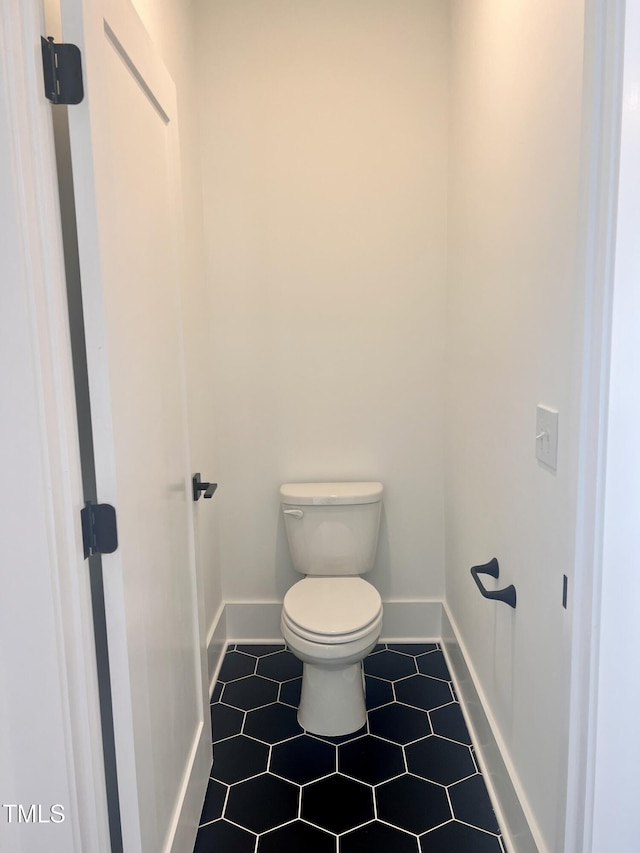 bathroom with tile patterned flooring and toilet