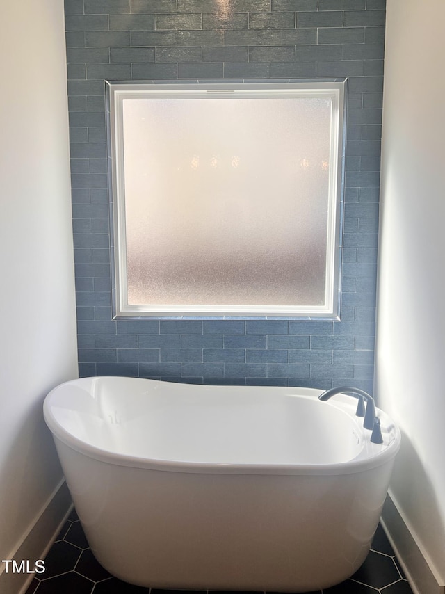 bathroom featuring tile patterned floors and a tub