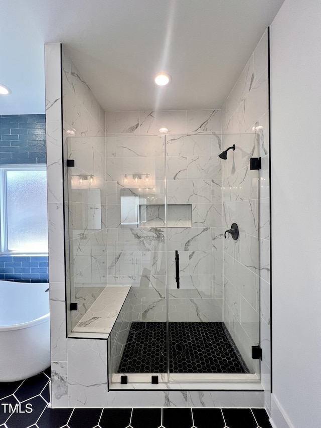 bathroom featuring shower with separate bathtub