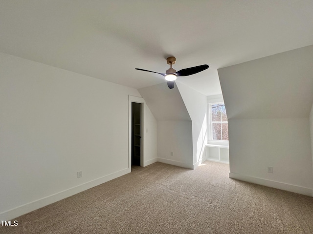 bonus room with vaulted ceiling, ceiling fan, and light colored carpet