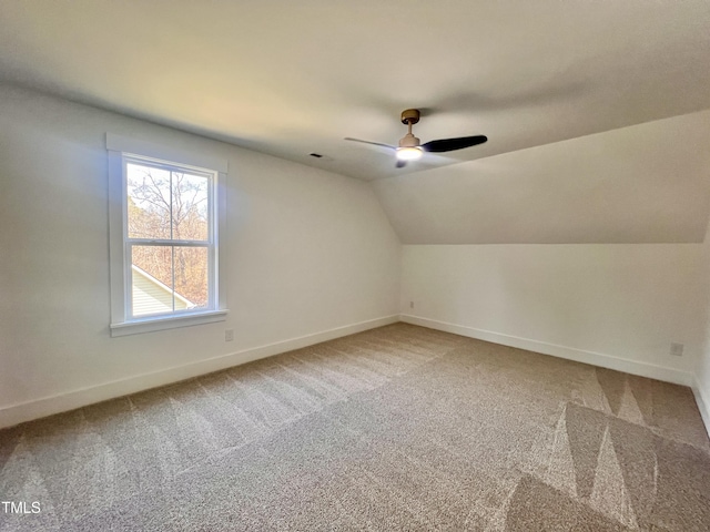 additional living space featuring ceiling fan, vaulted ceiling, and carpet