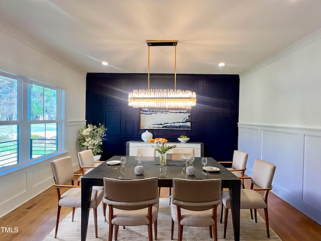 dining area with crown molding and wood-type flooring