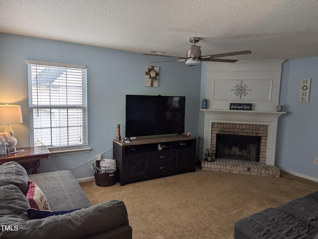 carpeted living room featuring a brick fireplace, a textured ceiling, and ceiling fan